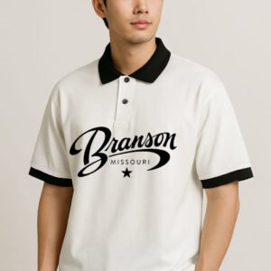 Step up your casual game with the Heritage Script Polo Shirt, a premium piece that blends classic style with bold graphics. This polo is crafted from a comfortable, breathable knit fabric in a crisp white color. The design is elevated by striking black contrast details on the collar, sleeve cuffs, and the prominenttwo-button placket and a relaxed fit, this shirt offers effortless style for a variety of occasions—from a casual Friday at the office to a weekend outing. It's the perfect choice for those who appreciate high-quality comfort and a distinctive, vintage-inspired look. Available in sizes S to XXL.